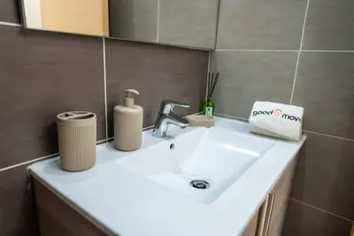 a bathroom sink with a soap dispenser on it at Sophisticated 3BR with Ample Space & Top Amenities in Rabat
