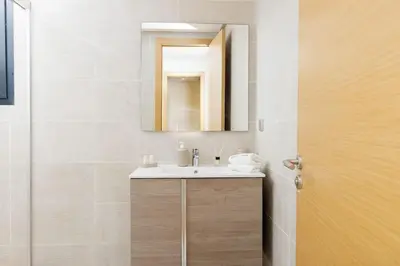 a bathroom with a sink and a mirror at Luxury 3BR Homelike Stay in Hay Riad in Rabat