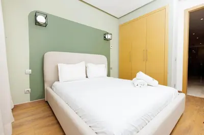 a bedroom with a large white bed with two white pillows at Luxury 3BR Homelike Stay in Hay Riad in Rabat