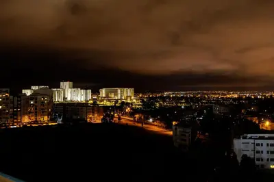 a view of a city at night with lights at Luxury 3BR Homelike Stay in Hay Riad in Rabat