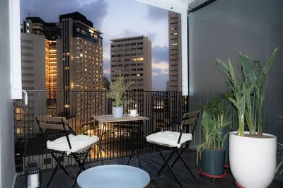 a balcony with tables and chairs and a city skyline at Fabuleux appart Casa port Marina in Casablanca