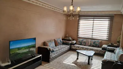 a living room with a couch and a flat screen tv at ANFA BLANCa in Casablanca