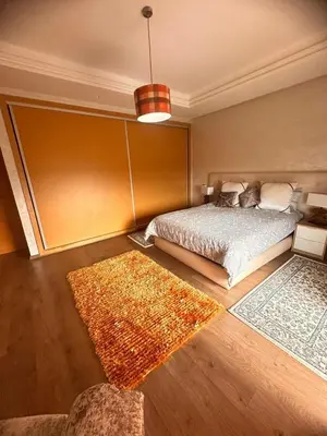 a bedroom with a bed and two rugs at Ferme de luxe in O Ben Slimane