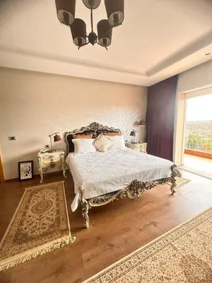 a bedroom with a large bed and a window at Ferme de luxe in O Ben Slimane