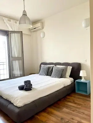 a bed with a teddy bear sitting on top of it at Élégant Appartement 200m Au Coeur De Casablanca ! in Casablanca