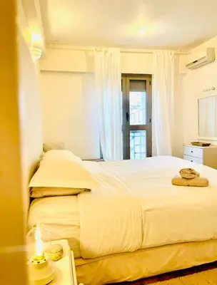 a bedroom with two beds and a table at Élégant Appartement 200m Au Coeur De Casablanca ! in Casablanca