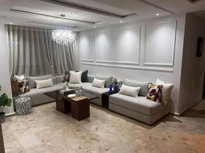 a living room with a couch and a table at Appartement de luxe à Casablanca in Aïn Sebaa