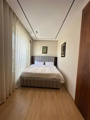 a bedroom with a bed and a large window at Studio Anfa Living 1 in Casablanca