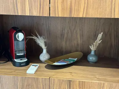 a shelf with vases and a clock and a remote control at Studio Anfa Living 1 in Casablanca