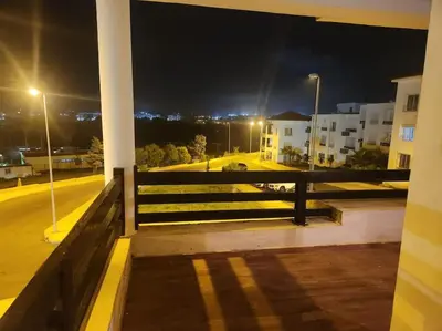 a balcony with a fence and a street at night at Apartment Ocean View 2Br in Casablanca