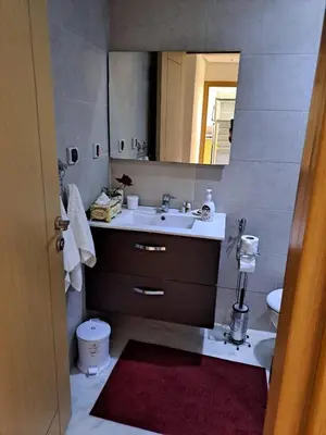 a bathroom with a sink and a mirror at les sables d'or in Temara