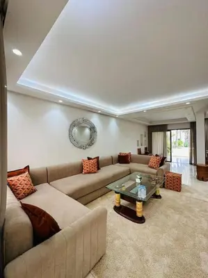 a living room with a couch and a glass table at villa pour location vacances in Tamaris