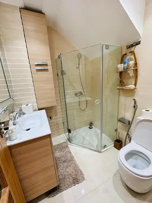 a bathroom with a shower and a toilet and a sink at villa pour location vacances in Tamaris