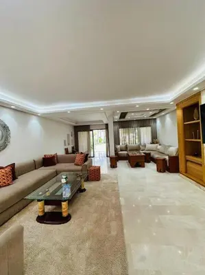 a large living room with a couch and a table at villa pour location vacances in Tamaris