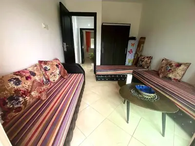 a living room with two couches and a table at Appartement, Salam Beach in Pont Blondin