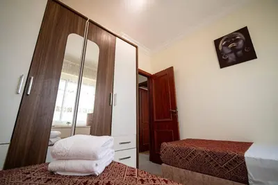 a hotel room with two beds and a mirror at Casablanca mosquée hassan 2 in Casablanca