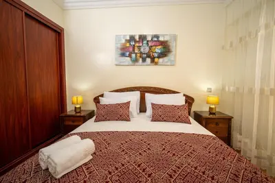 a bedroom with a large bed with two lamps at Casablanca mosquée hassan 2 in Casablanca