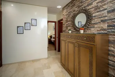 a bathroom with a mirror and a stone wall at Casablanca mosquée hassan 2 in Casablanca