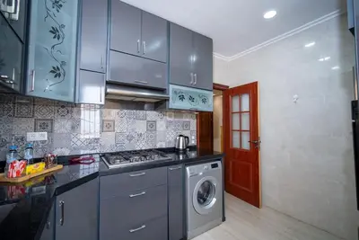 a kitchen with blue cabinets and a washing machine at Casablanca mosquée hassan 2 in Casablanca