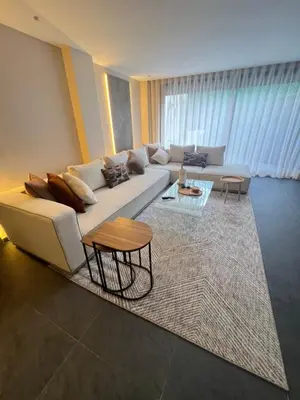 a living room with a couch and a table at Quart des hôpitaux duplex luxe et sérénité in Casablanca