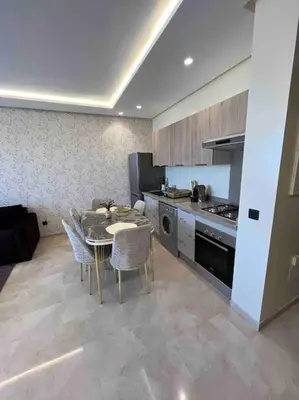 a kitchen with a table and chairs in a room at Perfect stay at CFC near Aeria Mall in Casablanca