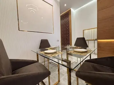 a dining room with a glass table and two chairs at Corniche Casablanca- Suite Luxueuse Gold Star in Casablanca