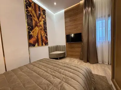 a bedroom with a bed and a chair in it at Corniche Casablanca- Suite Luxueuse Gold Star in Casablanca