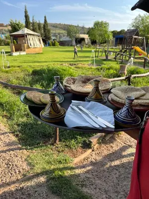 a table with napkins and vases on it in a park at Espace happy village settat in Settat