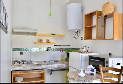 a white kitchen with a sink and a stove at Espace happy village settat in Settat