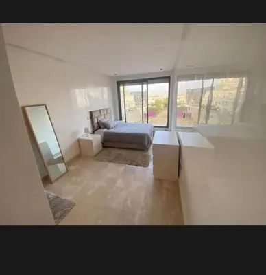 a bedroom with a bed and a large window at 2 bedroom cozy apartment ,near CFC,in center casablanca in Casablanca