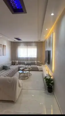 a living room with a couch and a tv at أجمل شقة الوفاق in Temara