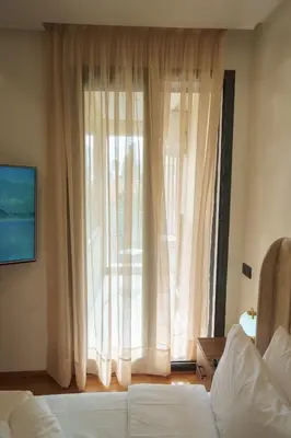 a bedroom with a bed and a large window at Emplacement Central Lumineux & Chic Prés de Station Tramway KFC Et Carrefour Abdelmoumen Et 2 Mars Casablanca in Casablanca