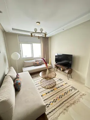 a living room with a couch and a tv at Ksar Labhar City Escape in Rabat