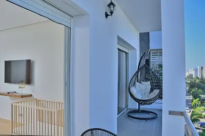a room with a balcony with a view of a city at YourPlace - Modern, Spacious 3BR in Prestigia in Rabat
