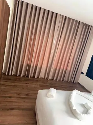 a hotel room with a white bed and a window at 35 Appartement ensoleillé calme et NEUF in Casablanca