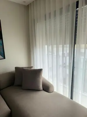 a couch in a room with a large window at 35 Appartement ensoleillé calme et NEUF in Casablanca