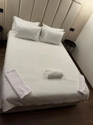 a white bed with a pillow on top of it at 36 Studio luxueux corniche 5 min in Casablanca
