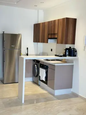a kitchen with a stove and a refrigerator at 36 Studio luxueux corniche 5 min in Casablanca