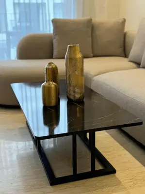 a living room with a couch and a table with a vase at 36 Studio luxueux corniche 5 min in Casablanca