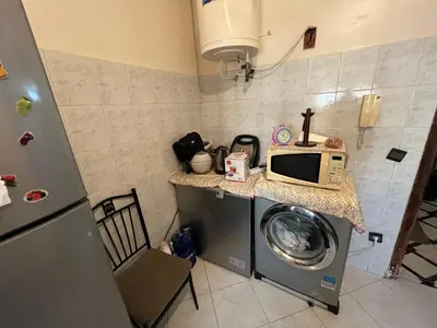 a kitchen with a washing machine and a microwave at Oulfa in Casablanca