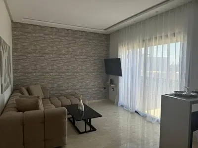 a living room with a couch and a table at 38 Studio luxueux- Corniche à 5 min in Casablanca