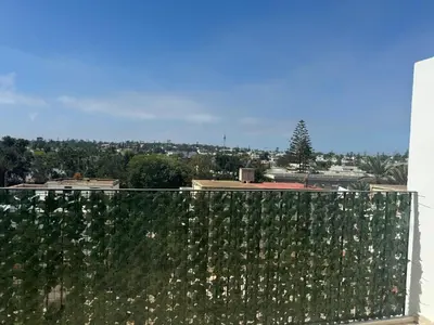 a fence with white flowers on top of a building at 38 Studio luxueux- Corniche à 5 min in Casablanca