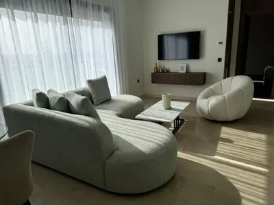 a living room with a couch and a chair at 47 Appartement luxueux proche de la mer in Casablanca