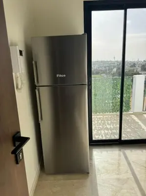 a stainless steel refrigerator in a room with a window at 47 Appartement luxueux proche de la mer in Casablanca