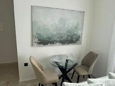 a dining room with a glass table and chairs at 47 Appartement luxueux proche de la mer in Casablanca