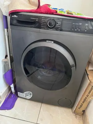 a washing machine in a box with a towel on top at Appartement calme in Tamaris