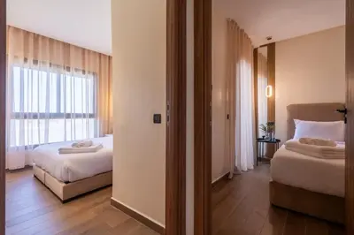 a hotel room with two beds and a window at Appartement Prestige et Confort in Casablanca