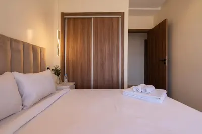 a bedroom with a large white bed with towels on it at Appartement Prestige et Confort in Casablanca