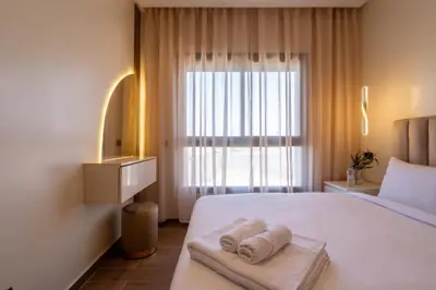 a bedroom with a large bed with towels on it at Appartement Prestige et Confort in Casablanca