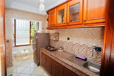 a kitchen with a sink and a refrigerator at Peaceful Apartment with AC & fiber-speed internet in Casablanca